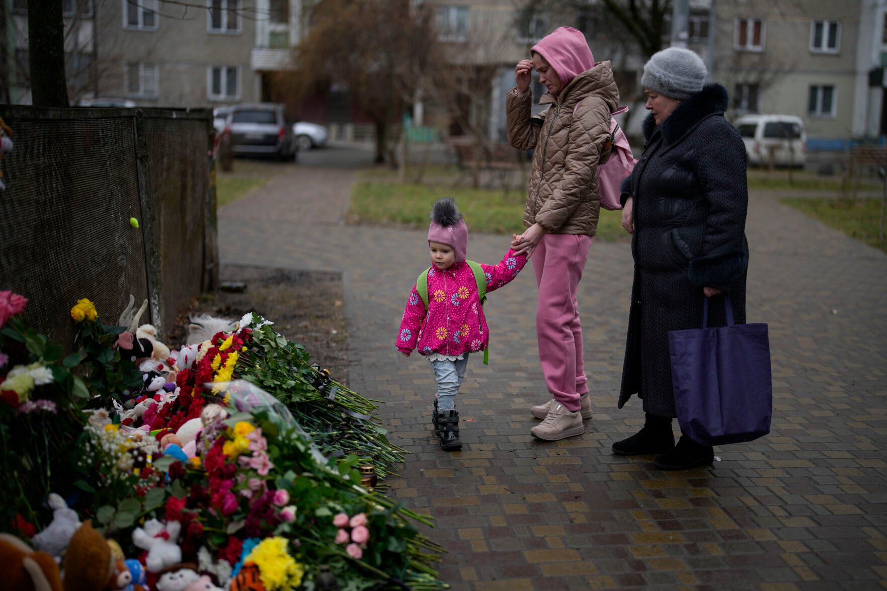 <p>People pay their respects Friday at the scene where a helicopter crashed Wednesday in Brovary, on the outskirts of Kyiv, Ukraine.</p>