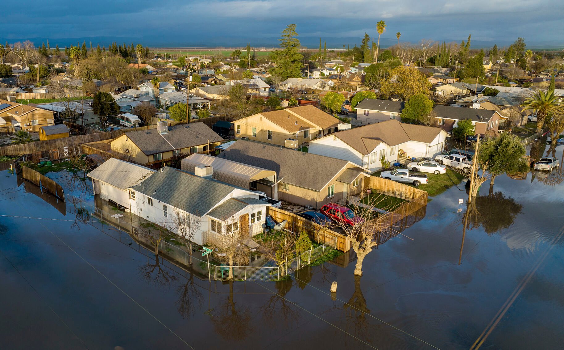 <p>Following days of rain, floodwaters cover streets Jan. 10 in the Planada community of Merced County, Calif.</p>
