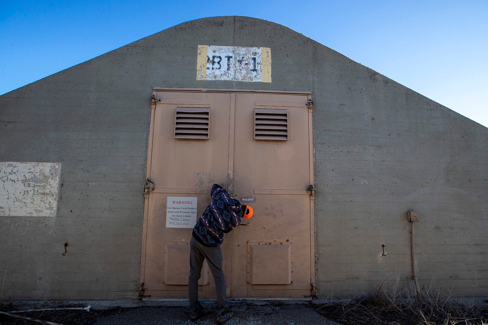 <p>U.S. Geological Survey biologist Jared Heath unlocks the doors of a concrete and steel WWII munitions bunker on the former El Toro Marine Corp Air Station on Wednesday, Dec. 14, 2022, in Irvine, California. The bunker is used to store an important collection of invertebrates. (Brian van der Brug/Los Angeles Times/TNS)</p>
