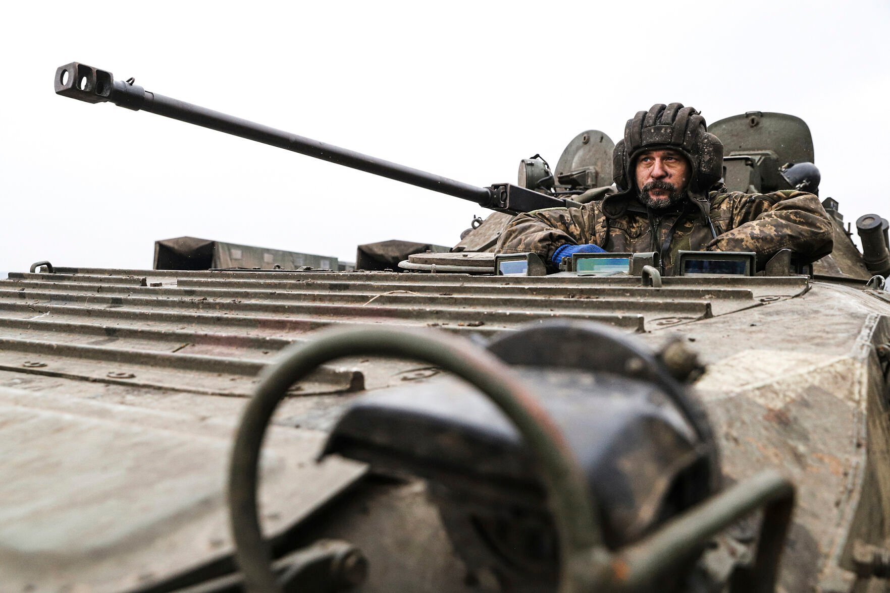 <p>A Ukrainian soldier looks out of an APC on Tuesday during combat training in Zaporizhzhia region, Ukraine.</p>