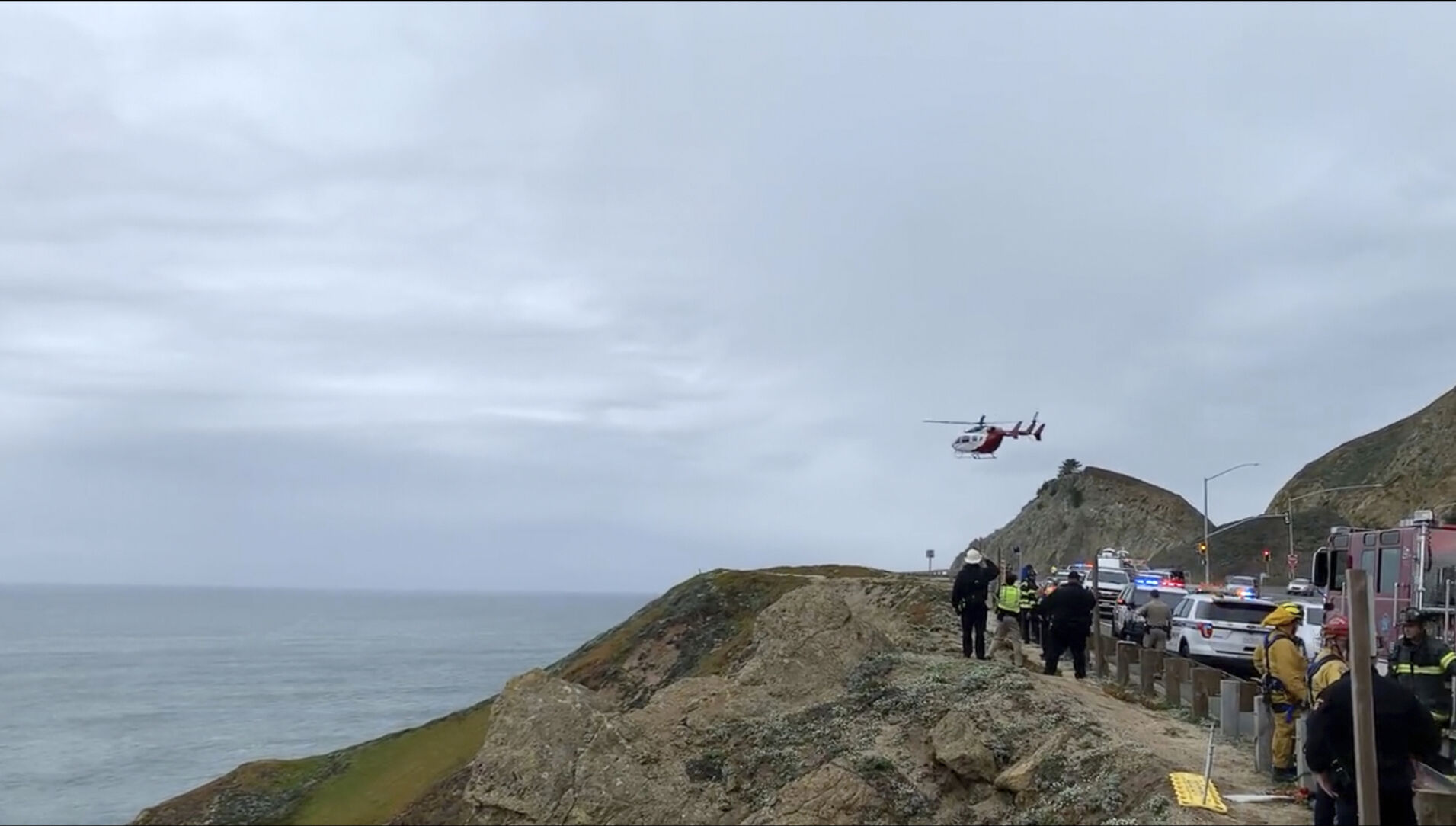 <p>In this image from video provided by Cal Fire San Mateo, Santa Cruz Unit, emergency personnel respond to the scene after a Tesla plunged off a cliff along the Pacific Coast Highway, Monday, Jan. 2, 2023, in Northern California, near an area known as Devil's Slide, leaving four people in critical condition, a fire official said.</p>