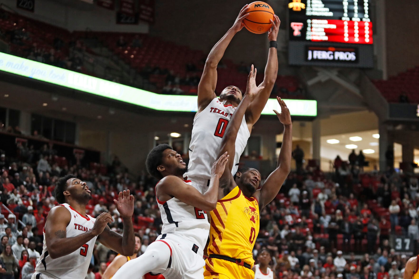 <p>Texas Tech's Kevin Obanor, top, rebounds the ball over teammate Kerwin Walton, second from left, and Iowa State's Tre King, right, during the first half of Monday's game in Lubbock, Texas.</p>