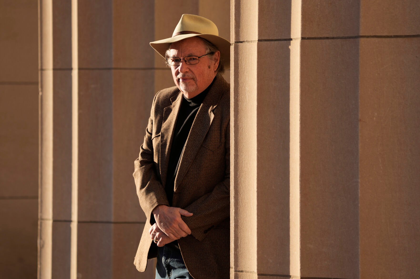 <p>Max McCoy, the lone journalism professor at Emporia State University, poses for a photo on Jan. 4 in front of the school's administration building in Emporia, Kan. McCoy was was one of 33 mostly tenured professors fired at the school.</p>