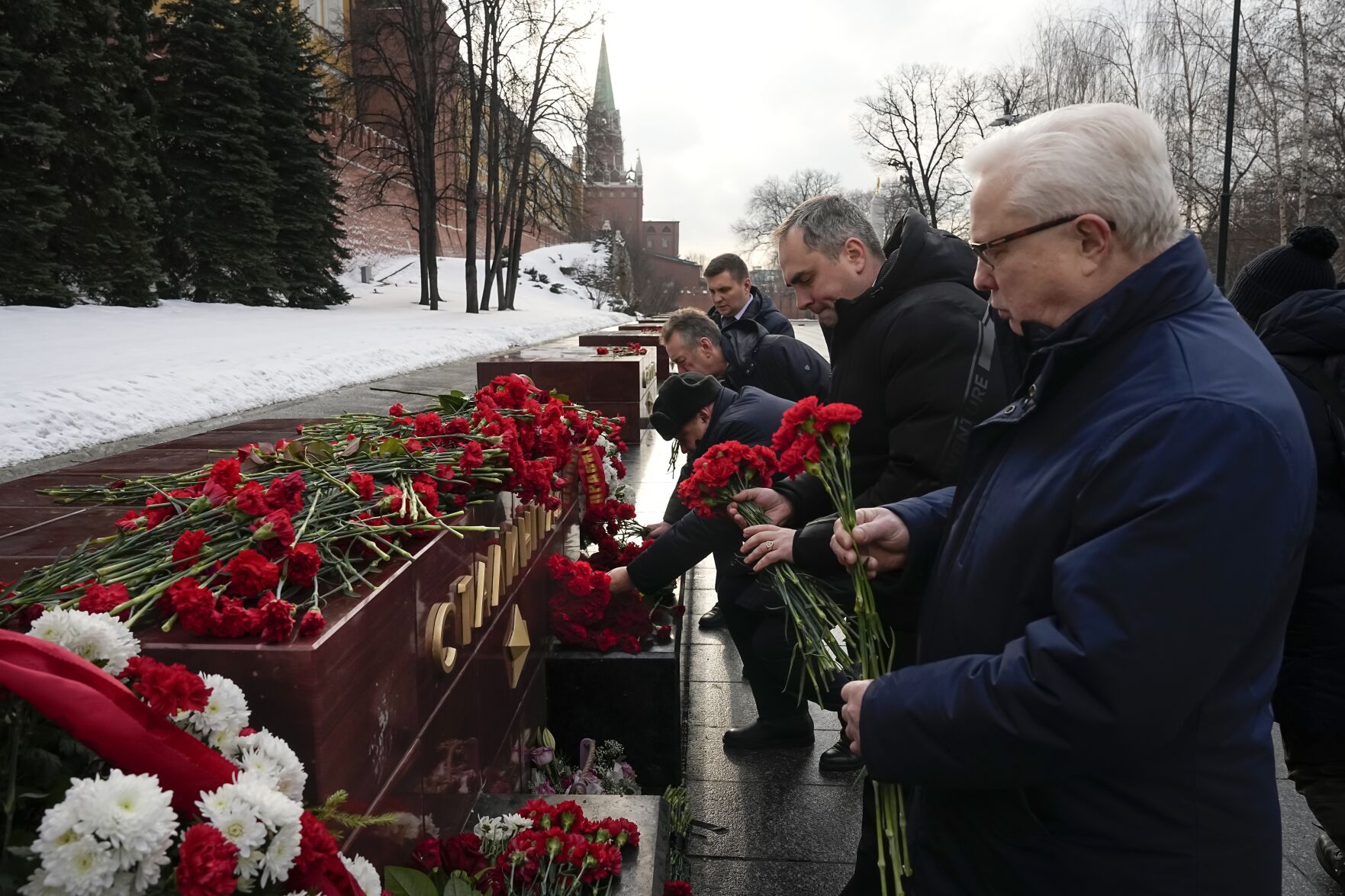 <p>People lay flowers at the Tomb Stalingrad during a wreath-laying ceremony Thursday at the Tomb of the Unknown Soldier near the Kremlin Wall in Moscow as Russia marks the 80th anniversary of the Soviet victory in the battle of Stalingrad.</p>