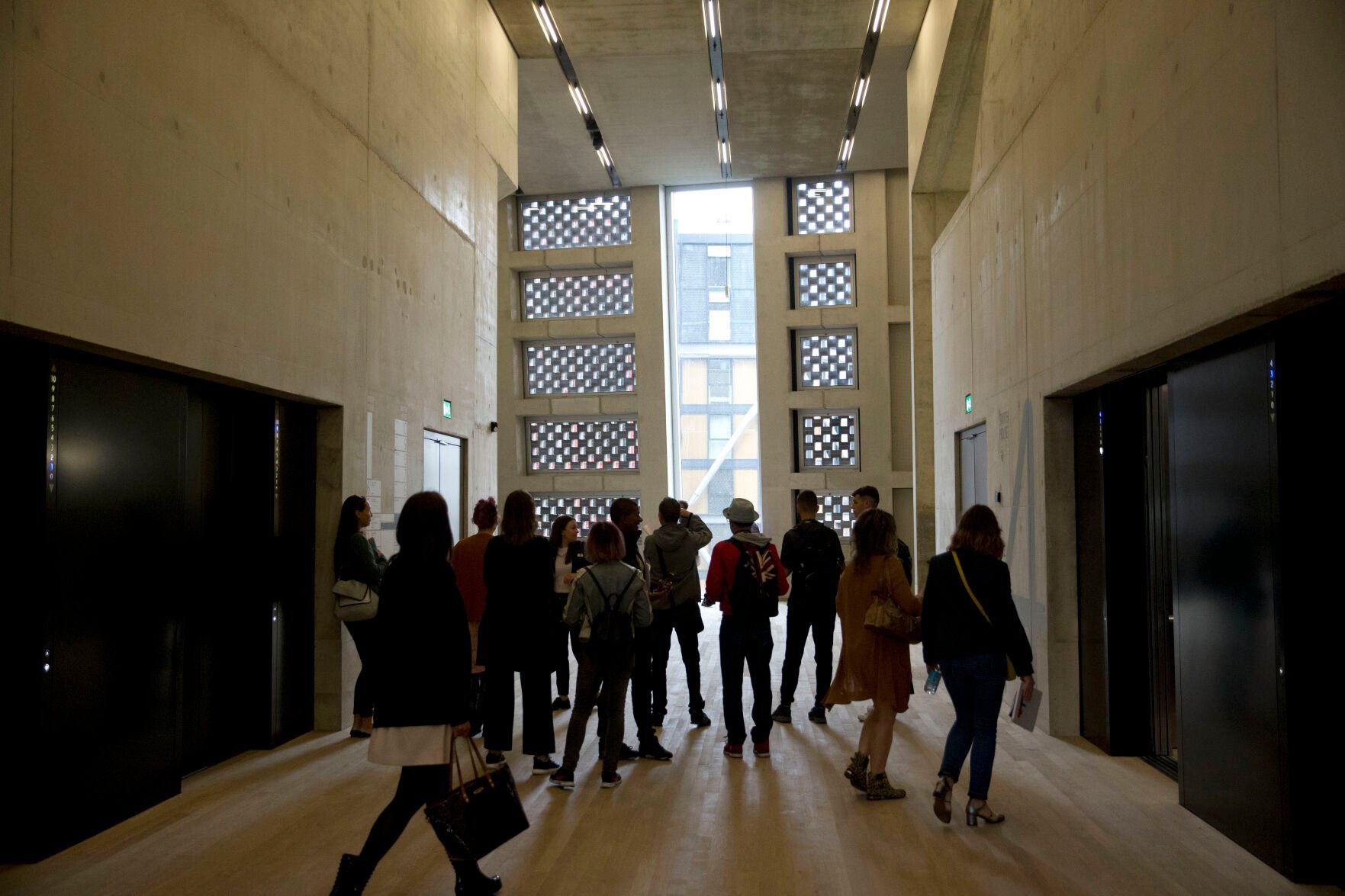 <p>People stand in an area by the elevators in the new Switch House building extension to the Tate Modern gallery on June 14, 2016, in London.</p>