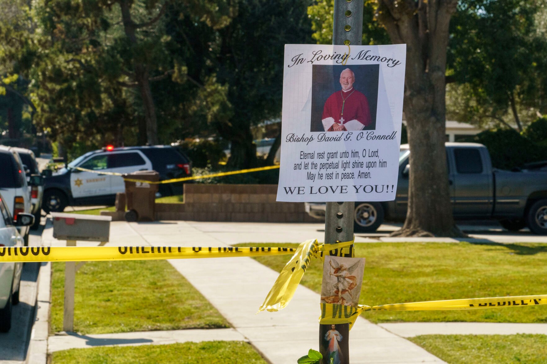<p>An image of Bishop David O'Connell is posted on the post of a street sign near his home in Hacienda Heights, Calif., Sunday, Feb. 19, 2023. </p>