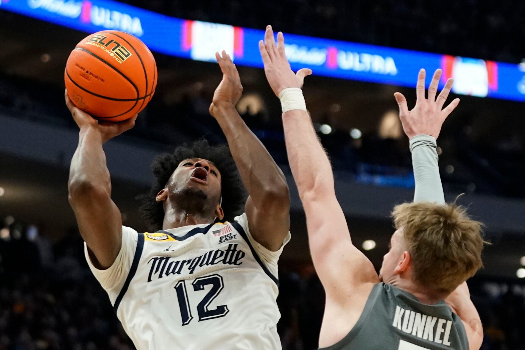 <p>Marquette's Olivier-Maxence Prosper shoots against Xavier's Adam Kunkel during the first half of Wednesday's game in Milwaukee.</p>