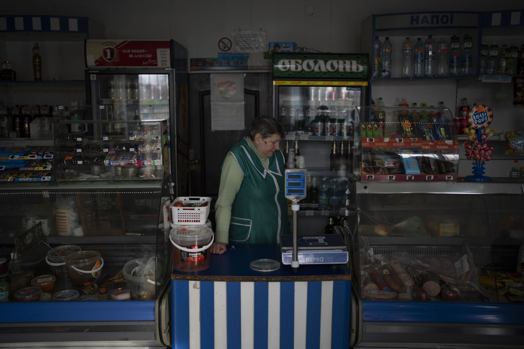 <p>A shopkeeper waits for customers Feb. 1 close to the border with Belarus, Ukraine.</p>