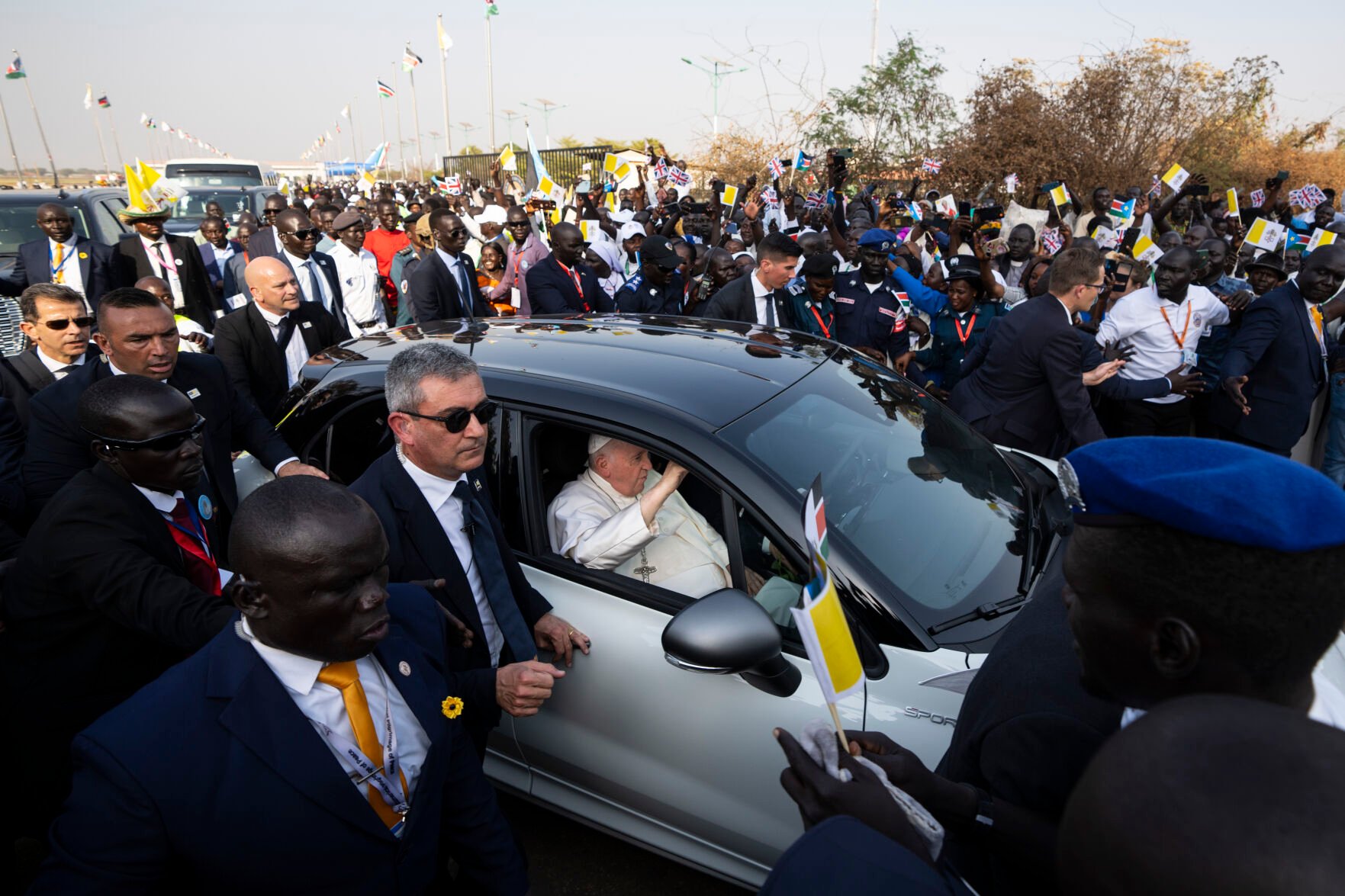 <p>Pope Francis leaves in his vehicle past crowds gathered Friday at the entrance to the airport in Juba, South Sudan.</p>