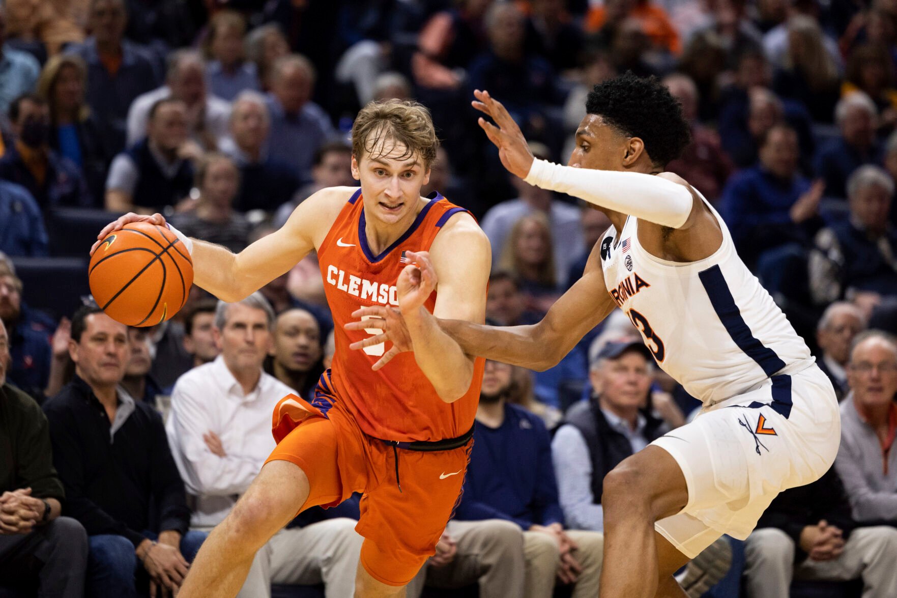 <p>Clemson's Hunter Tyson, left, drives ball past Virginia's Ryan Dunn during the first half of Tuesday's game in Charlottesville, Va.</p>
