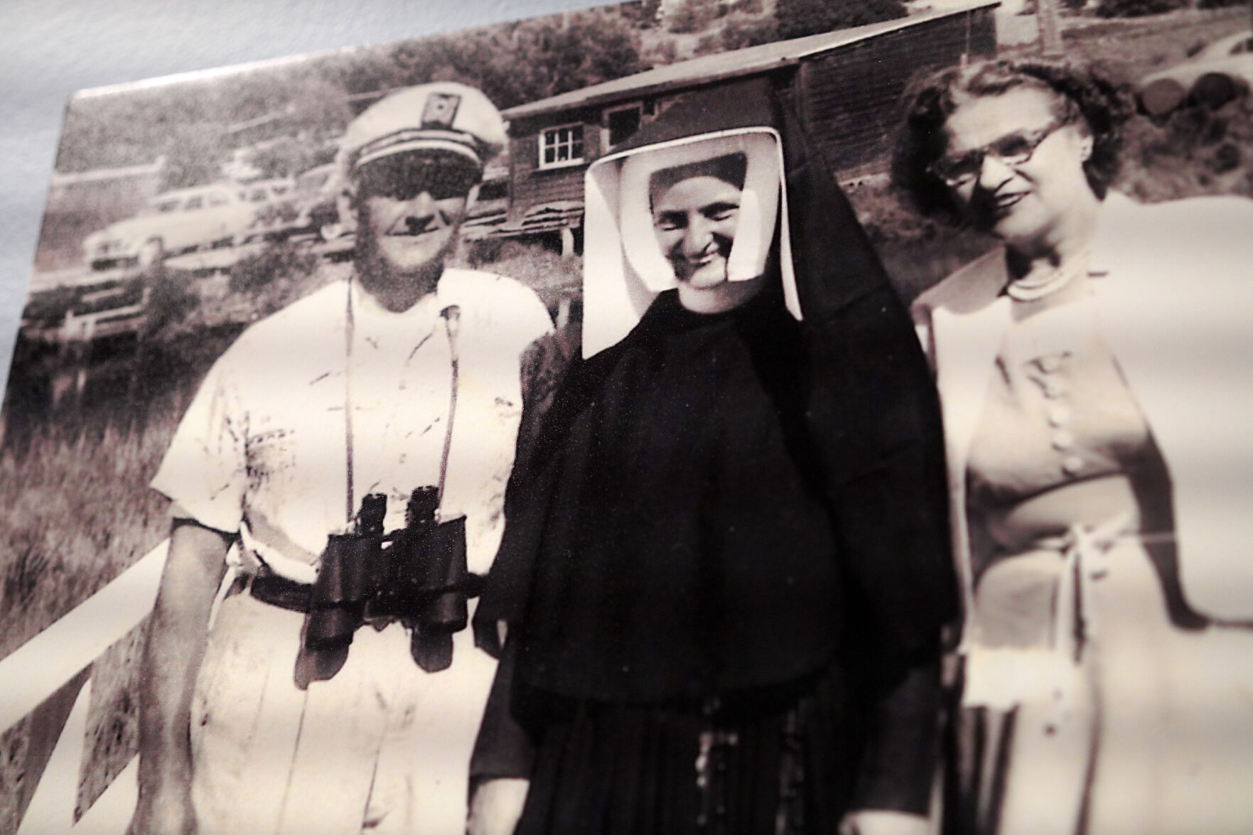 <p>A photo of Sister Jean Dolores Schmidt, center, and her parents, hangs in a museum gallery dedicated to the now 103-year-old Catholic nun, at Loyola University.</p>