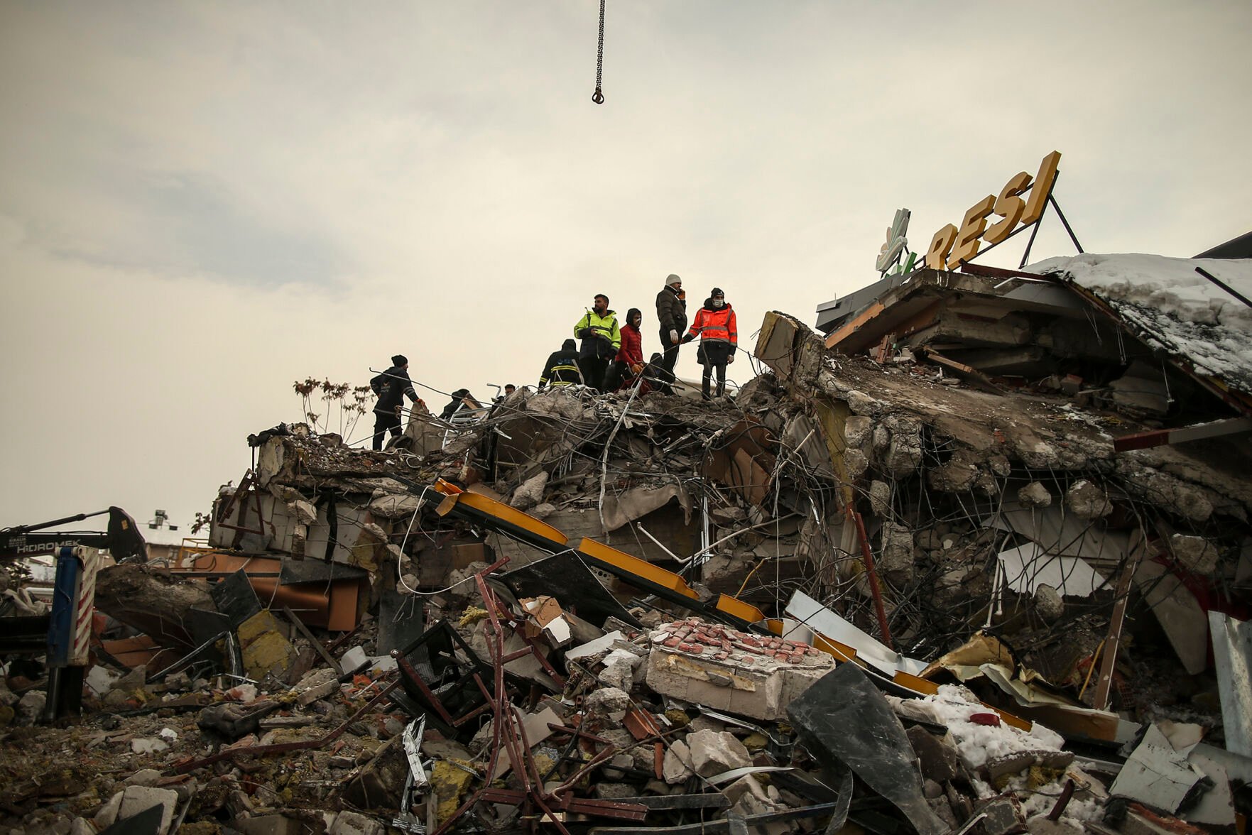 <p>Rescue workers search for survivors Tuesday on a collapsed building in Malatya, Turkey.</p>