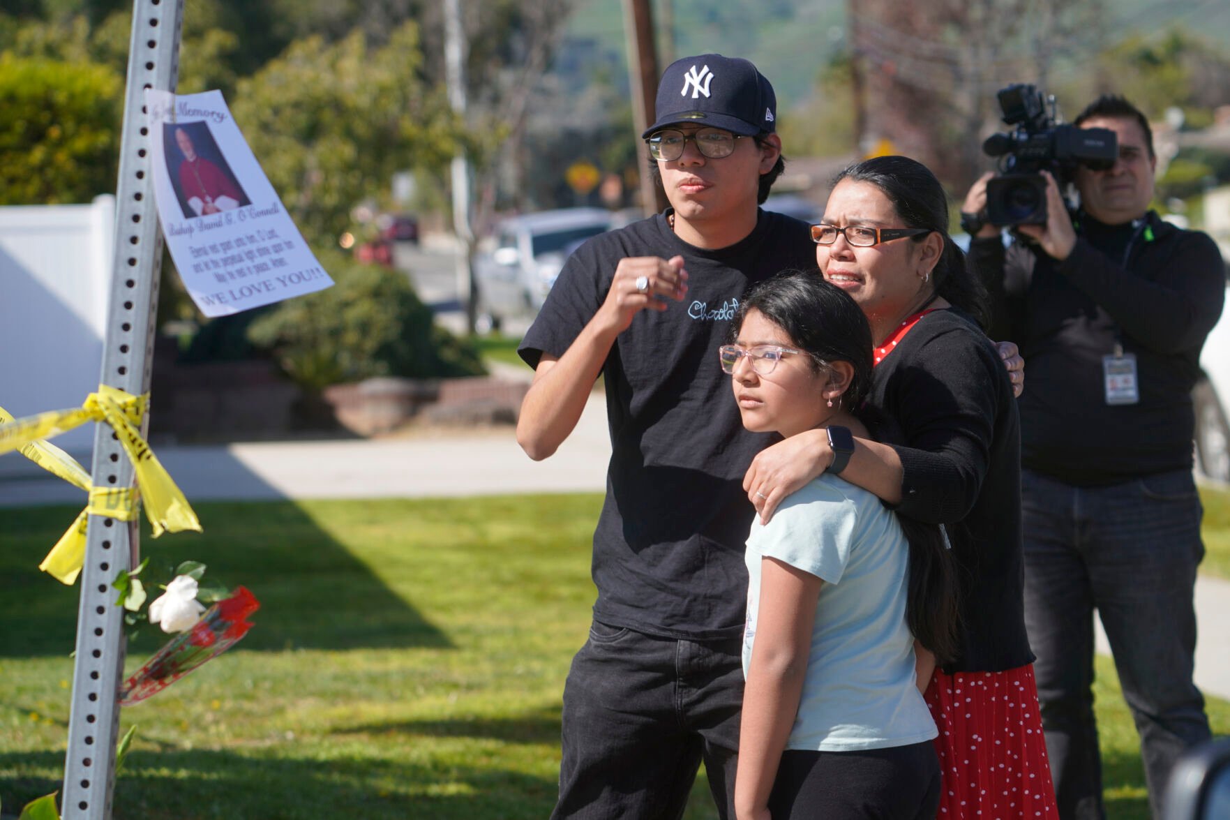 <p>Gabriela Gil and her children pay their respects to Bishop David O'Connell at the corner of his home in Hacienda Heights, Calif., Sunday, Feb. 19, 2023. </p>