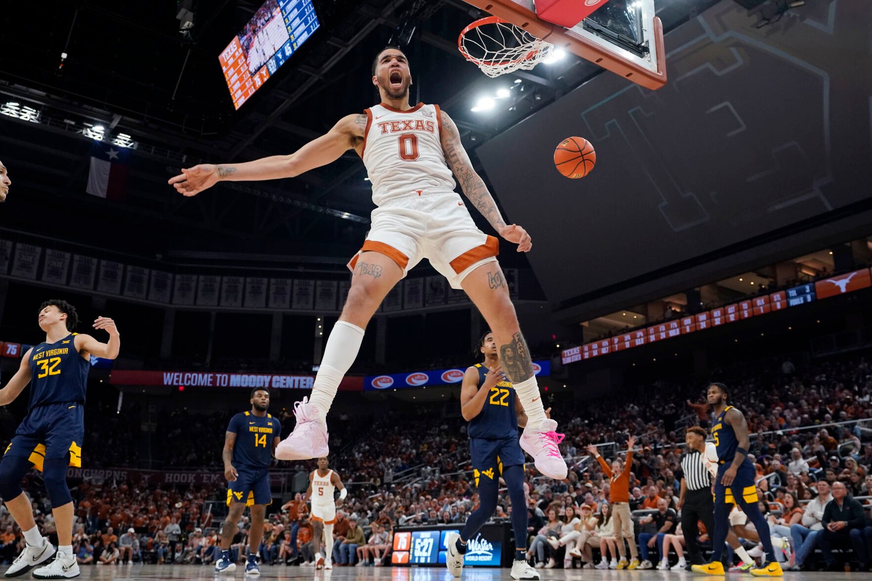 <p>Texas forward Timmy Allen celebrates as he scores against West Virginia during the second half of Saturday's game in Austin, Texas.</p>