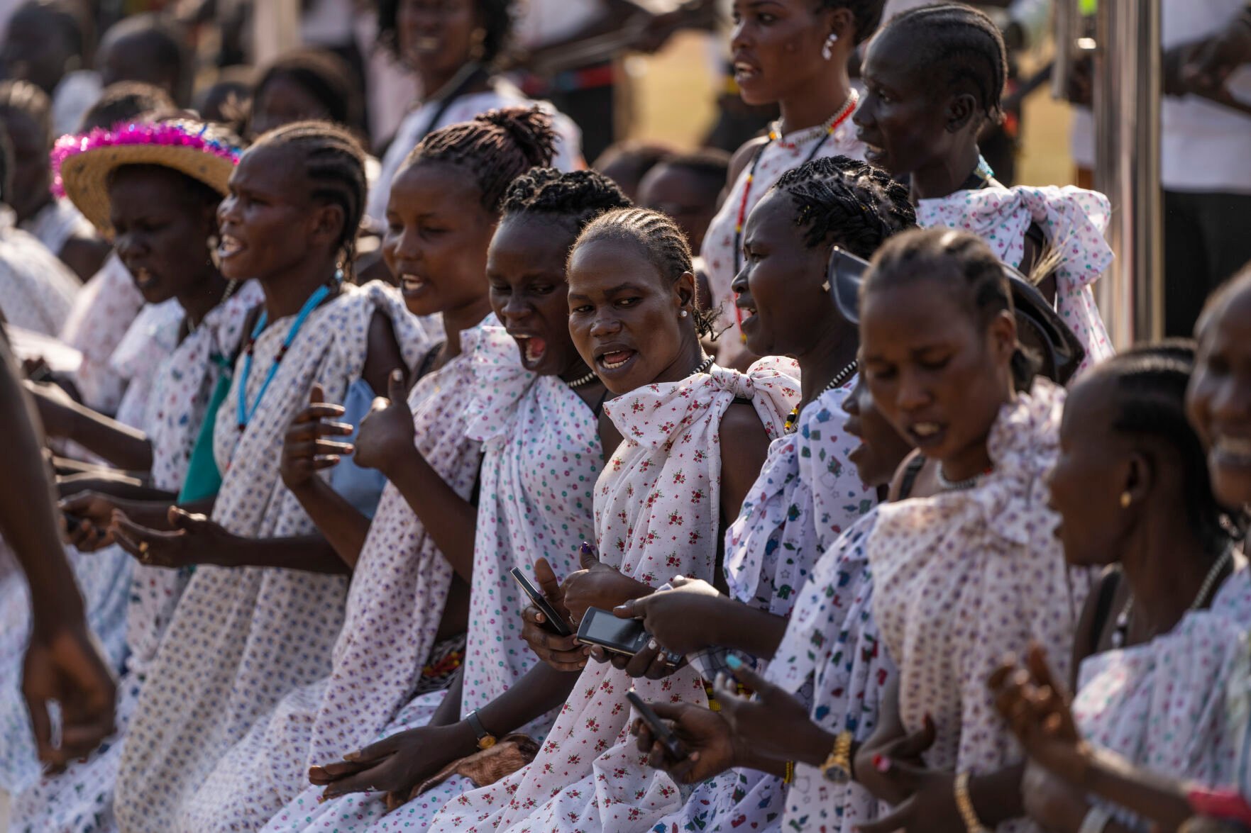 <p>A group of women sing at the side of the airport exit Friday as Pope Francis prepares to leave in his vehicle from the airport in Juba, South Sudan.</p>