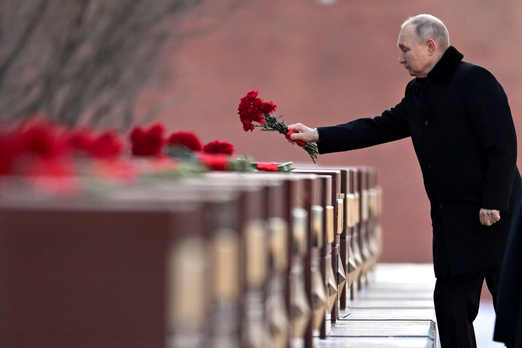 <p>Russian President Vladimir Putin attends a wreath-laying ceremony at the Tomb of the Unknown Soldier, near the Kremlin Wall during the national celebrations of the "Defender of the Fatherland Day" on Thursday in Moscow.</p>