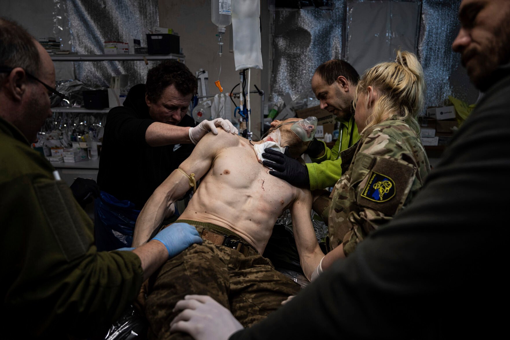 <p>Ukrainian military medics treat their wounded comrade at the field hospital Sunday near Bakhmut, Ukraine.</p>
