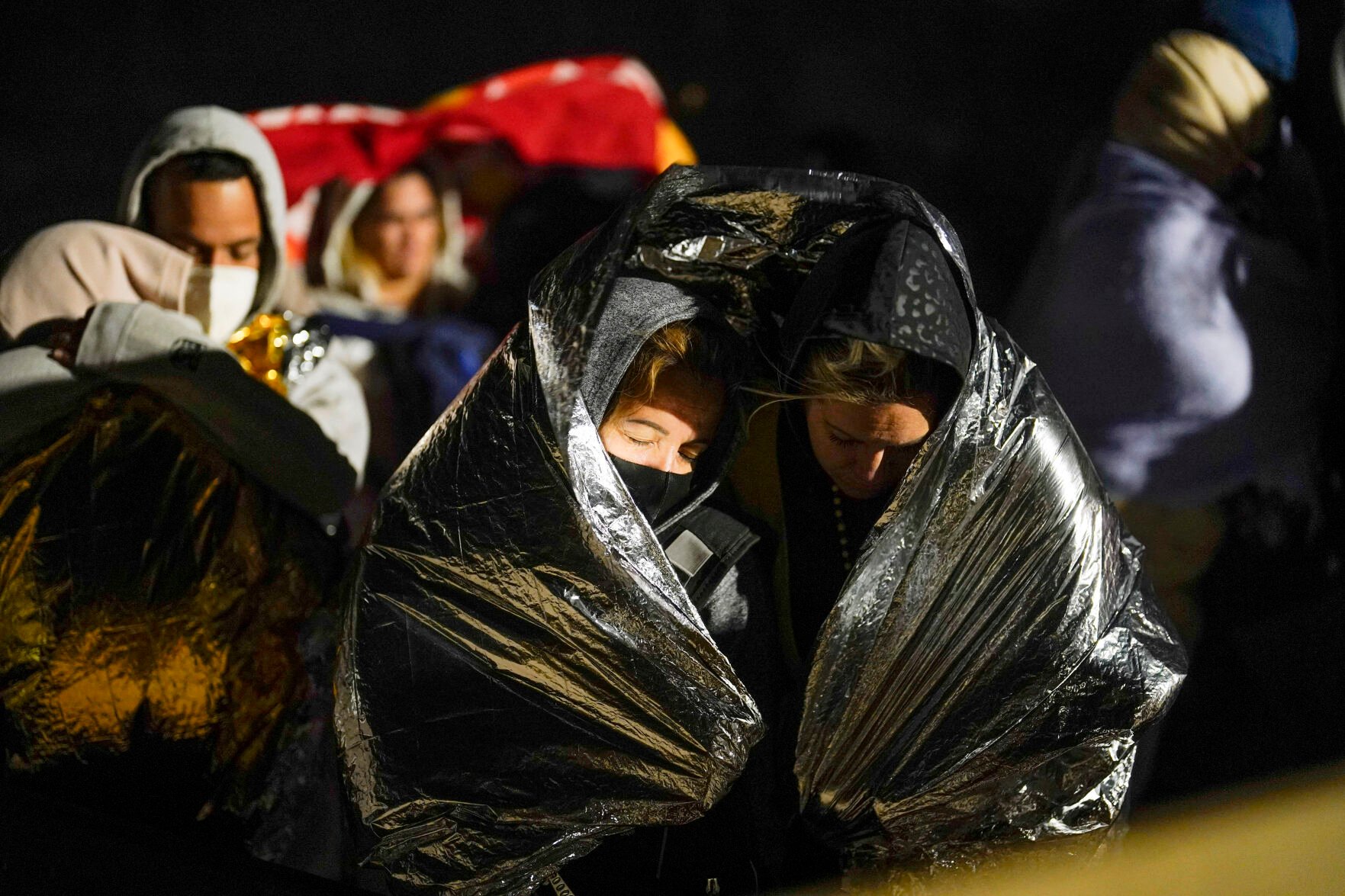 <p>Two women from Cuba try to keep warm Nov. 3, 2022, after crossing the border from Mexico and surrendering to authorities to apply for asylum near Yuma, Arizona.</p>