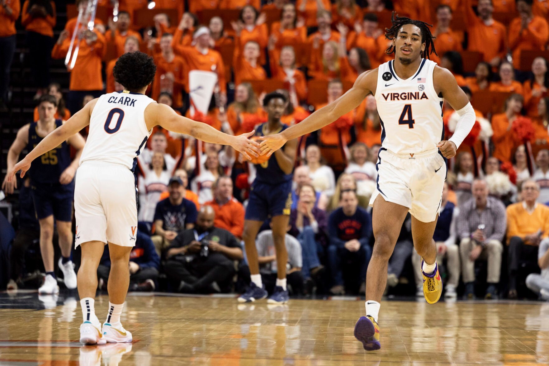 <p>Virginia's Kihei Clark and Armaan Franklin celebrate during the first half of Saturday's game against Notre Dame in Charlottesville, Va.</p>