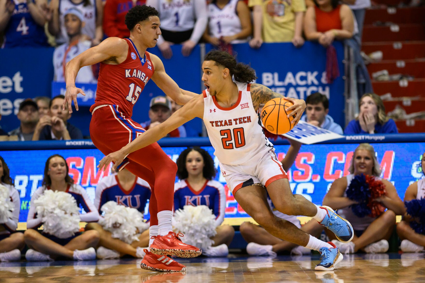 <p>Texas Tech guard Jaylon Tyson, right, drives around Kansas guard Kevin McCullar Jr. during the first half of Tuesday's game in Lawrence, Kan.</p>