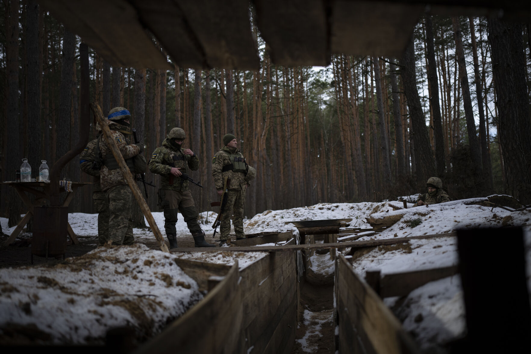 <p>Ukrainian servicemen stand at a position Feb. 1 close to the border with Belarus, Ukraine.</p>