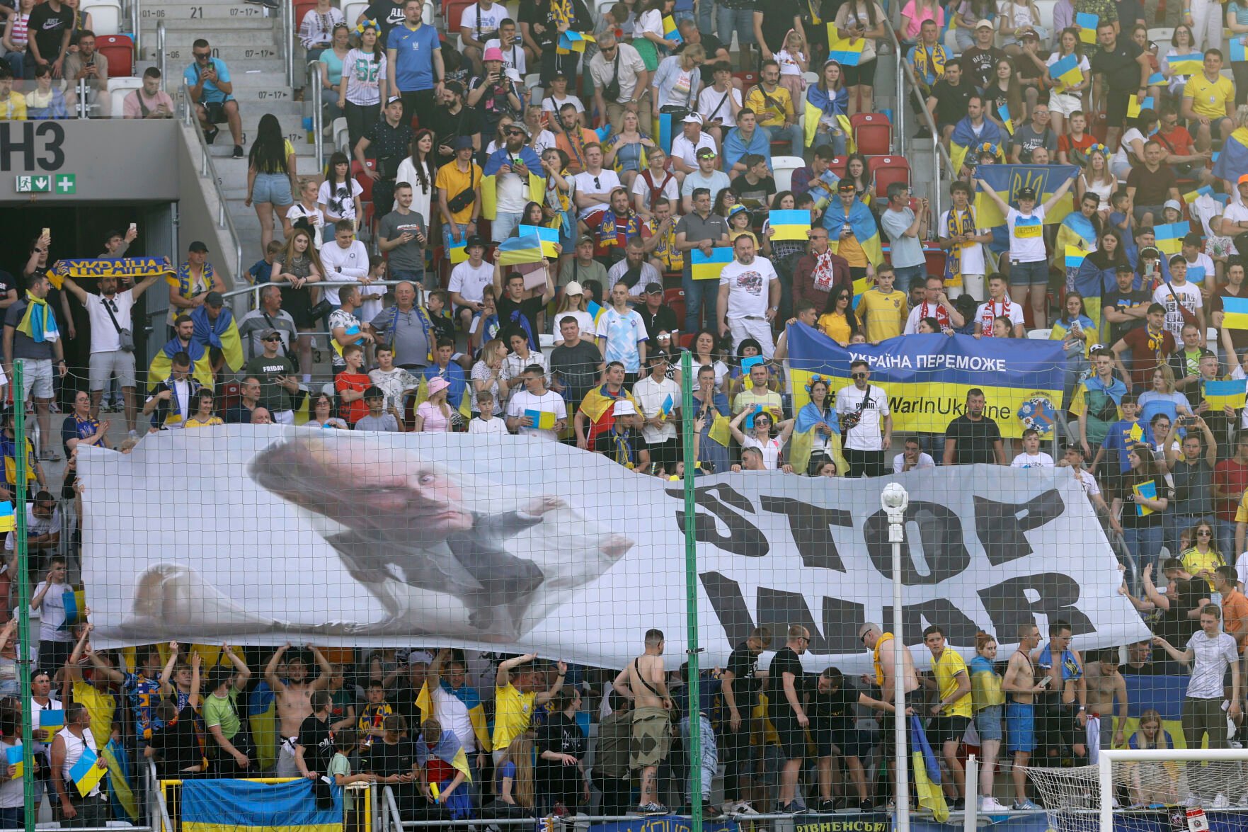 <p>Ukraine supporters unfurl a "Stop War" banner on the stands during the UEFA Nations League soccer match between Ukraine and Armenia, in Lodz, Poland, on June 11, 2022.</p>