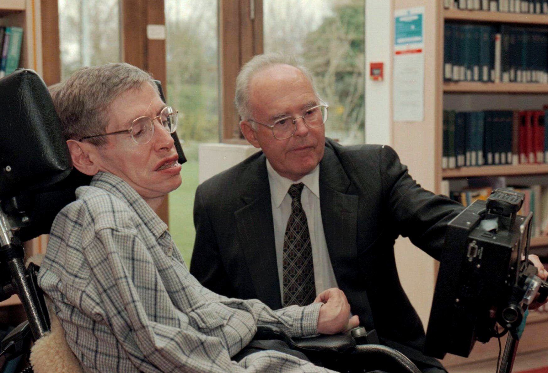 <p>FILE Physicist Stephen Hawking, left, looks at a new custom-built computer designed especially for him with Dr. Gordon Moore of the Intel Corporation in the library of The Issac Newton Institute of Mathematics in Cambridge, England, Thursday, March 20, 1997. Moore, the Intel Corp. co-founder who set the breakneck pace of progress in the digital age with a simple 1965 prediction of how quickly engineers would boost the capacity of computer chips, has died. He was 94. Intel and the Gordon and Betty Moore Foundation say Moore died Friday, March 24, 2023 at his home in Hawaii. (AP Photo, File)</p>