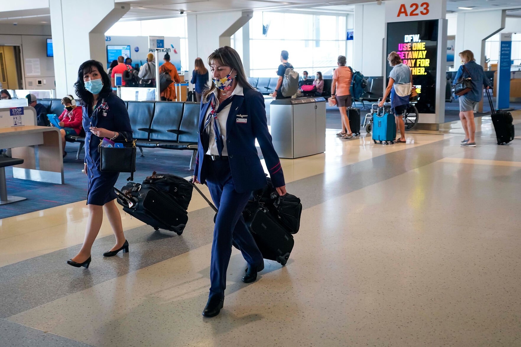 <p>American Airlines flight attendants walk along the concourse at DFW International Airport. (Smiley N. Pool/Dallas Morning News/TNS)</p>