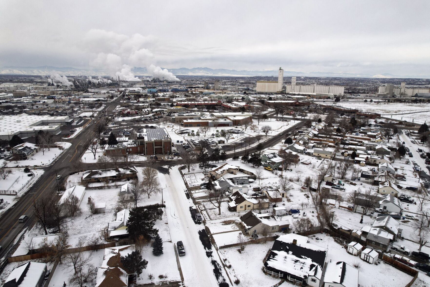 <p>Homes that flank an industrial zone are seen from the air Feb. 23 in Commerce City, Colo. Although a facility was built to treat water contamination in Commerce City, it sparked long-simmering distrust in the predominantly Latino neighborhood.</p>