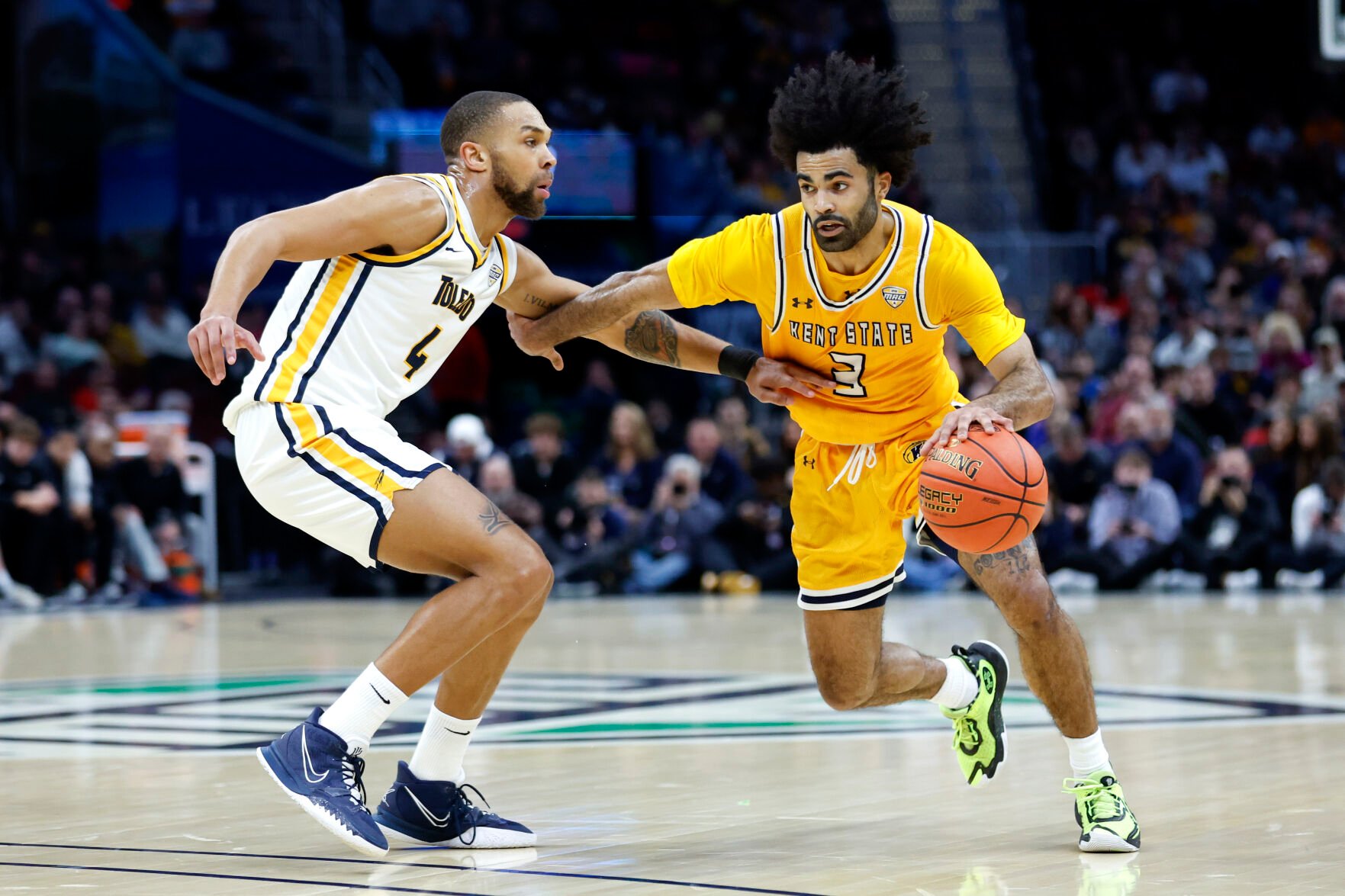 <p>Kent State guard Sincere Carry drives against Toledo forward Setric Millner Jr. during the championship of the Mid-American Conference tournament last Saturday.</p>