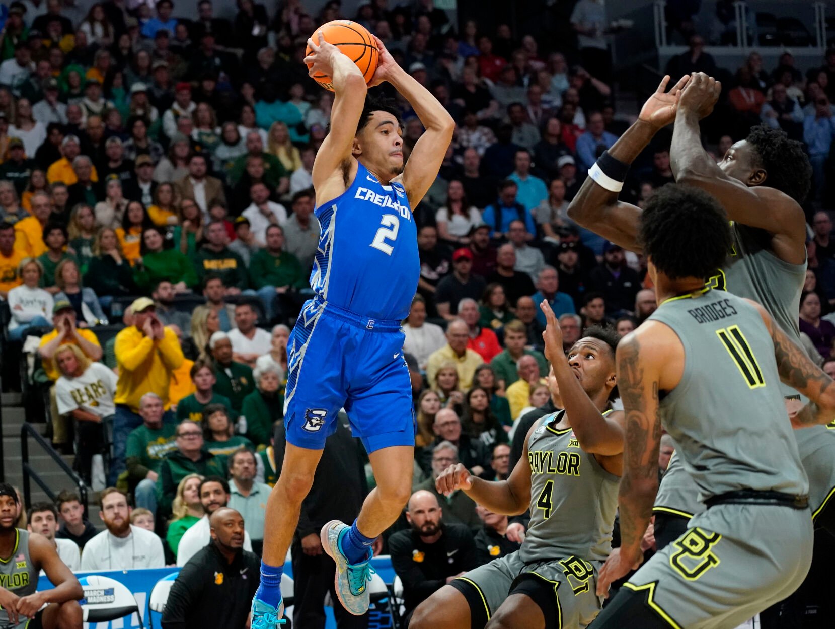 <p>Creighton guard Ryan Nembhard, left, looks to pass the ball as Baylor forward Jalen Bridges, front right, forward Jonathan Tchamwa Tchatchoua and guard LJ Cryer defend during a second-round NCAA Tournament game on Sunday in Denver.</p>