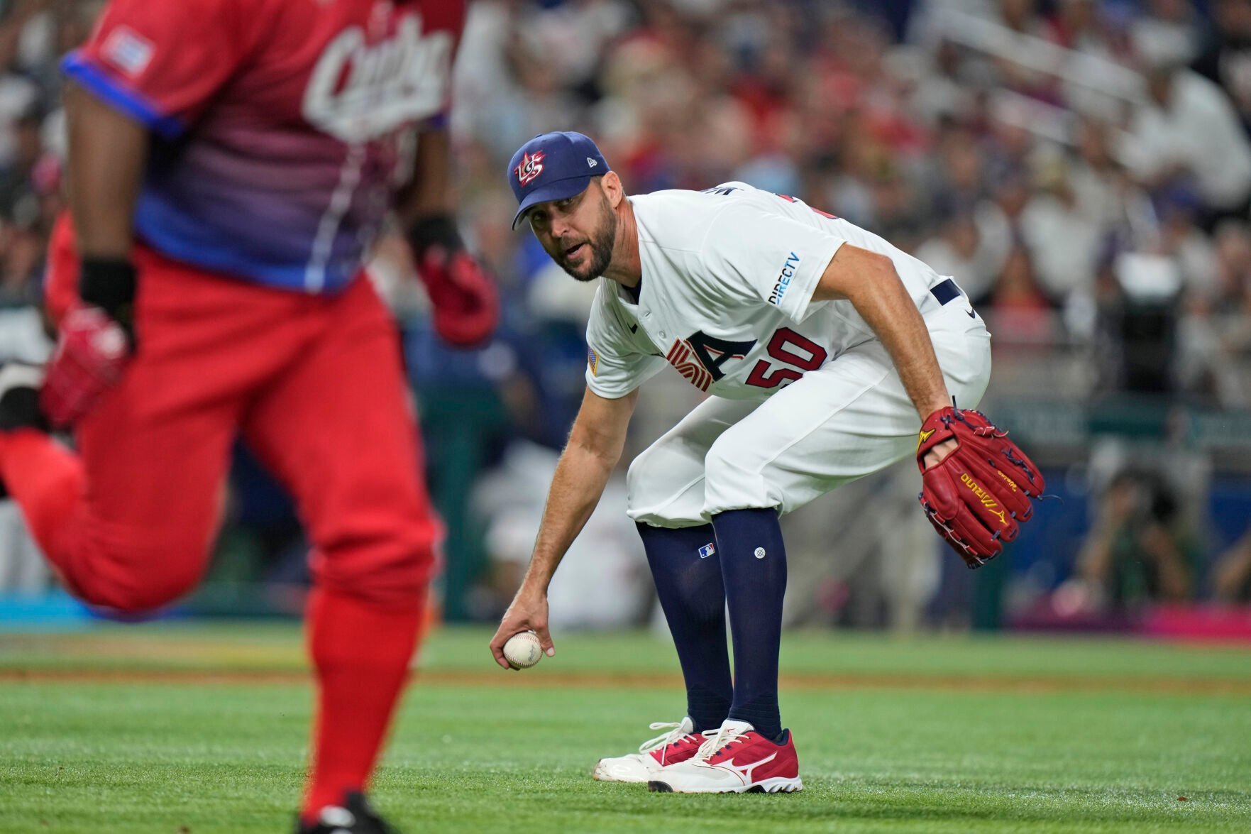 <p>U.S. pitcher Adam Wainwright attempts to throw out Cuba's Alfredo Despaigne, left, at first during the third inning of a World Baseball Classic game on Sunday in Miami.</p>