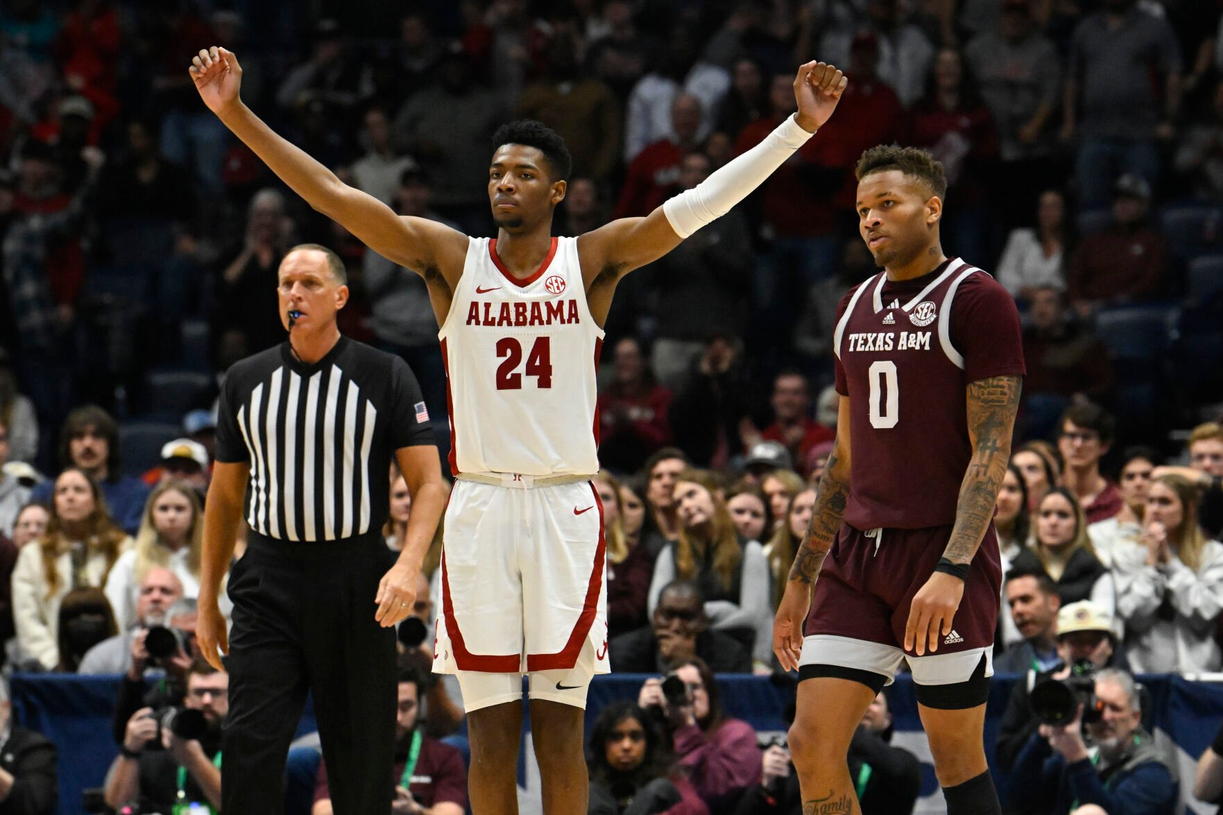<p>Alabama forward Brandon Miller reacts as Texas A&M guard Dexter Dennis looks on in the final minutes of Sunday's Southeastern Conference Tournament championship game in Nashville, Tenn.</p>