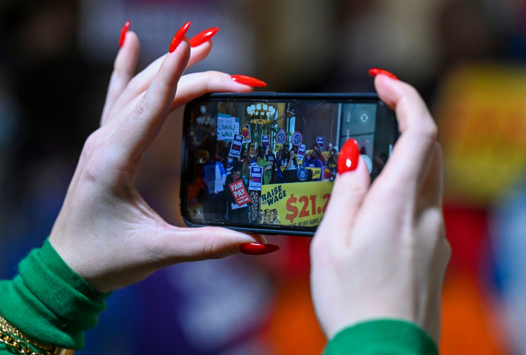 <p>Supporters document protesters urging lawmakers to raise New York's minimum wage during a rally March 13 at the state Capitol in Albany, N.Y. </p>