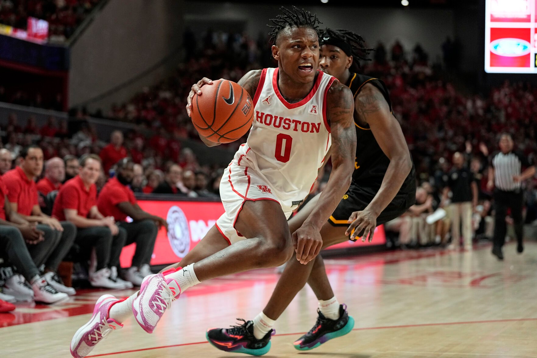 <p>Houston guard Marcus Sasser (0) drives around Wichita State guard Jaron Pierre Jr. during the second half of a March 2 game in Houston.</p>