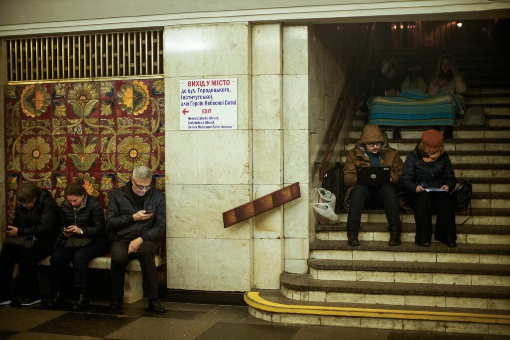 <p>People sit in the subway, using it as a bomb shelter during an air raid alarm, on Oct. 20 in Kyiv, Ukraine</p>