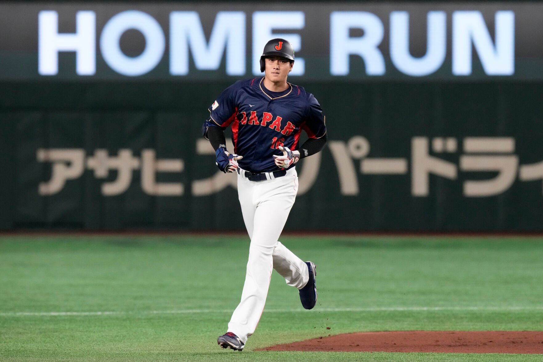 <p>Shohei Ohtani of Japan rounds the bases after hitting a 3-run home run in the 1rst inning against Australia during Sunday's Pool B game at the World Baseball Classic at the Tokyo Dome.</p>