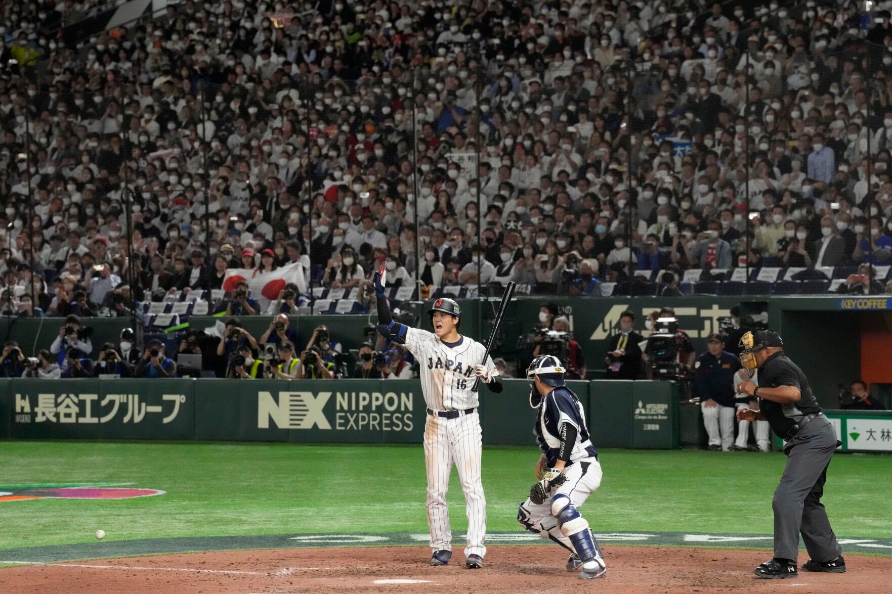 <p>Japan's Shohei Ohtani gestures to Takumu Nakano after a wild pitch by South Korea pitcher Lee Eui-lee during the seventh inning a WBC Group B game Friday at the Tokyo Dome.</p>