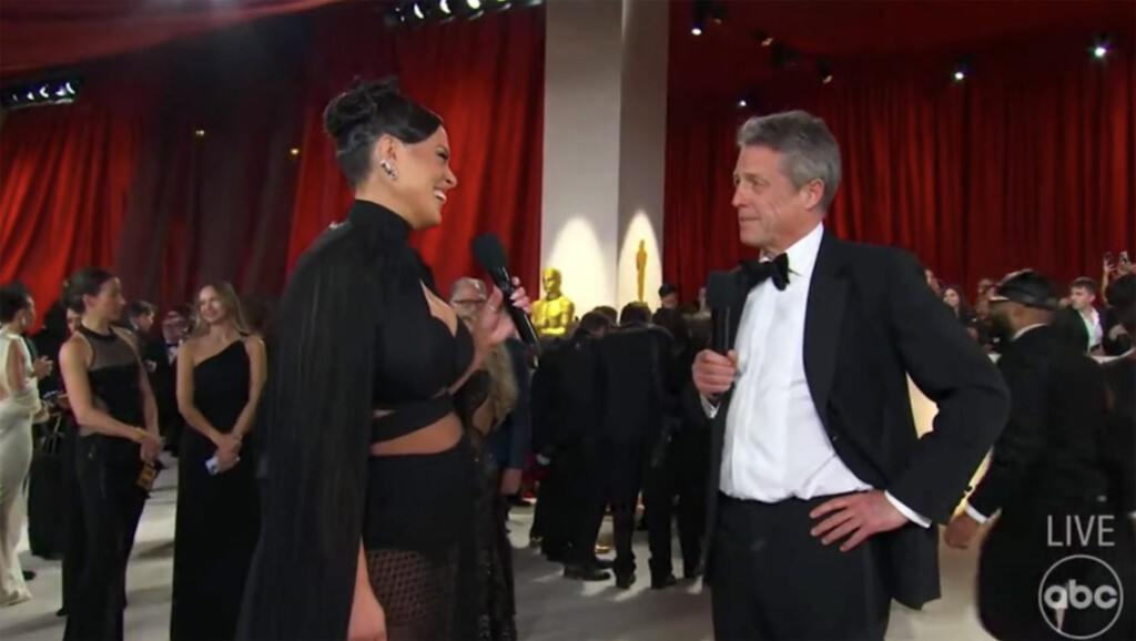 Hugh Grant’s Awkward Oscars Red Carpet Interview With Ashley Graham Divides Opinion
