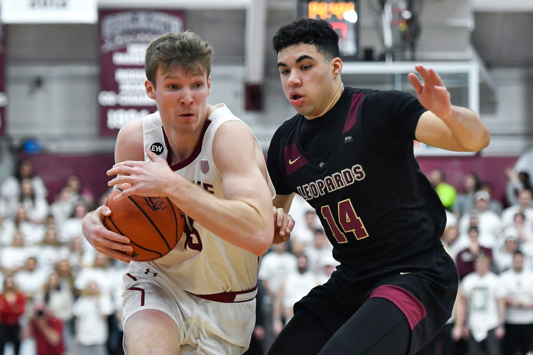 <p>Colgate guard Tucker Richardson is defended by Lafayette forward Kyle Jenkins during the Patriot League tournament championship on March 8.</p>