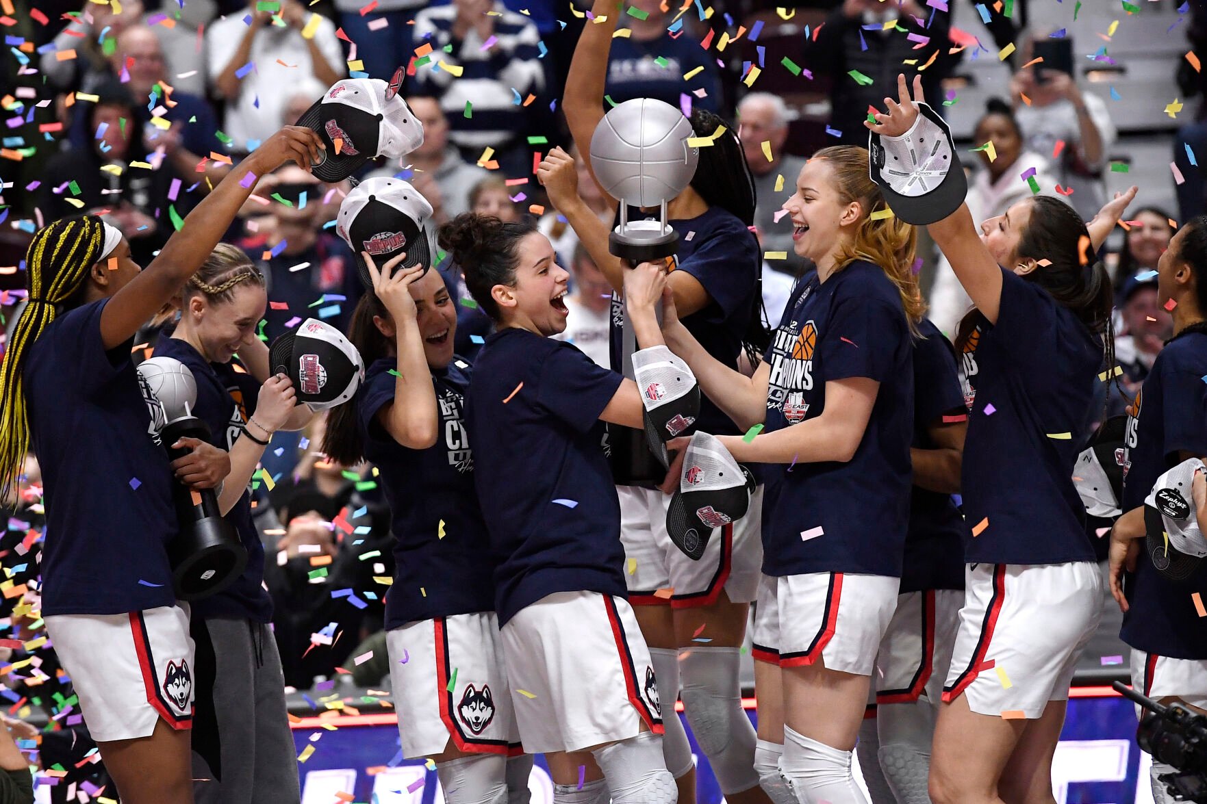 <p>UConn's Lou Lopez Senechal, center left, and Dorka Juhasz, center right, hold the Big East Championship trophy as they celebrate with teammate after defeating Villanova in the finals of the Big East Conference tournament, March 6, at Mohegan Sun Arena in Uncasville, Conn.</p>