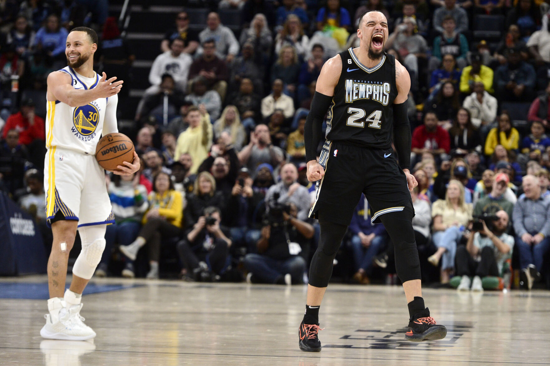 <p>Golden State's Stephen Curry, left, can't believe Memphis Grizzlies forward Dillon Brooks' reaction after a play on March 9.</p>