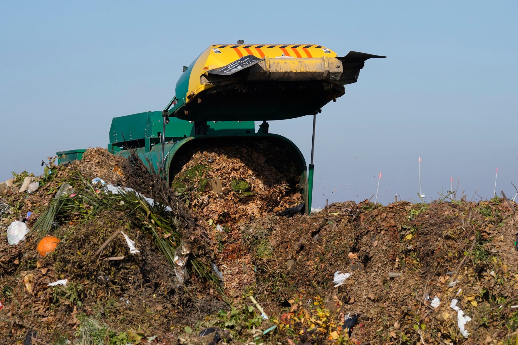 <p>FILE - A truck unloads organic waste to be used for composting at the Anaerobic Composter Facility in Woodland, Calif., on Nov. 30, 2021. Greenhouse gas emissions from the way humans consume food could add nearly one degree of warming to the Earth’s climate by 2100, according to a new study Monday, March 6, 2023. California started a mandatory food waste recycling program in 2021 to reduce the emissions created by decaying food. (AP Photo/Rich Pedroncelli, File)</p>