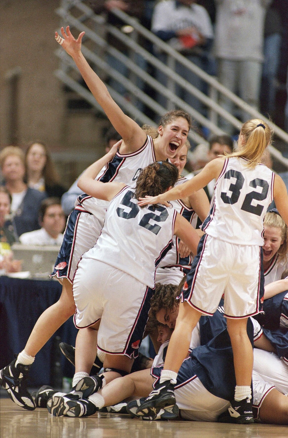<p>UConn's Rebecca Lobo, left, celebrates with teammates including Kara Wolters (52) and Pam Weber (32) after they defeated Virginia 67-63 to win the 1995 NCAA East Regional Championship. They went on to finish 35-0 that season.</p>