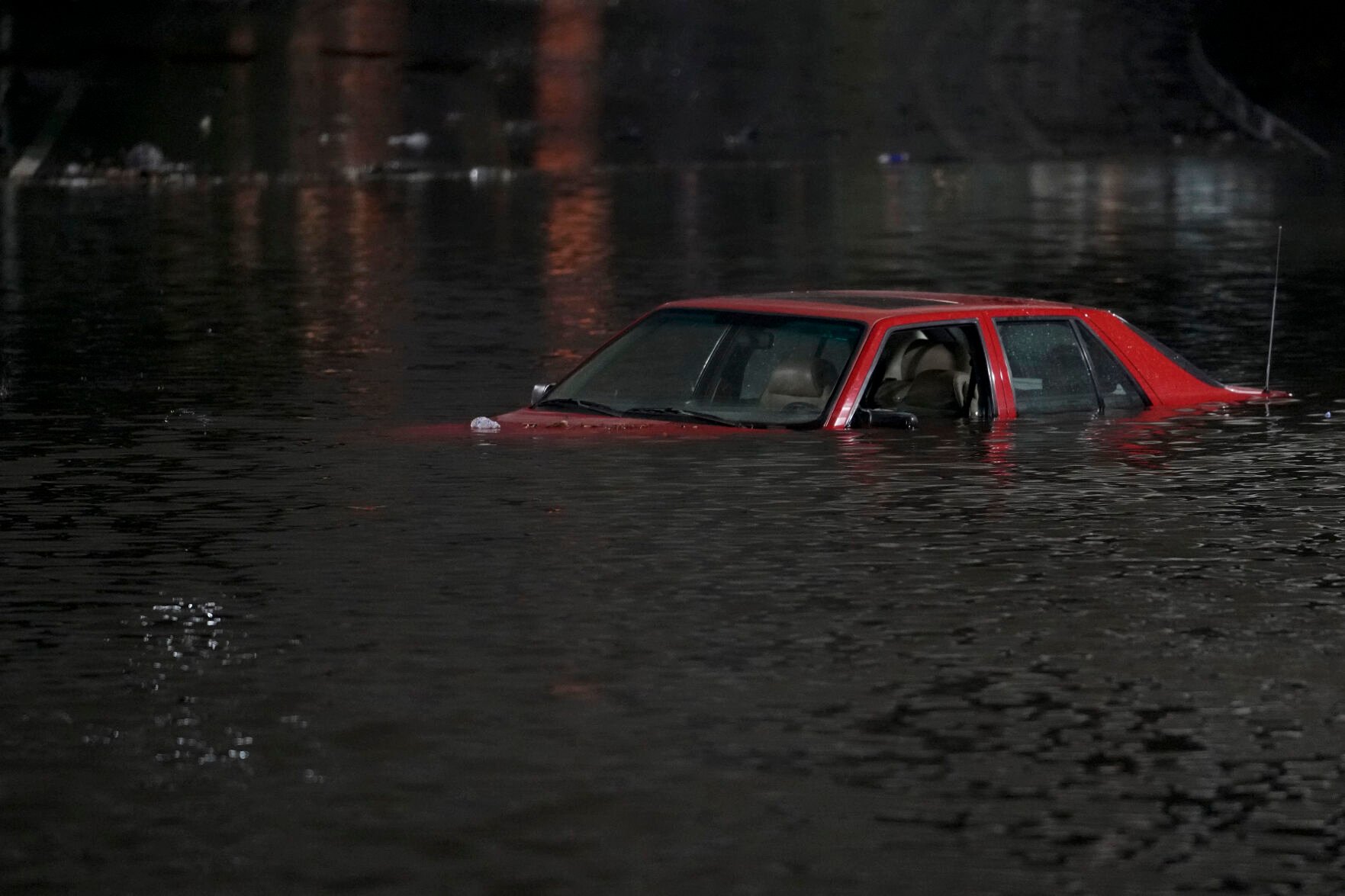 <p>An empty vehicle is surrounded by floodwaters Jan. 4 on a road in Oakland, Calif.</p>