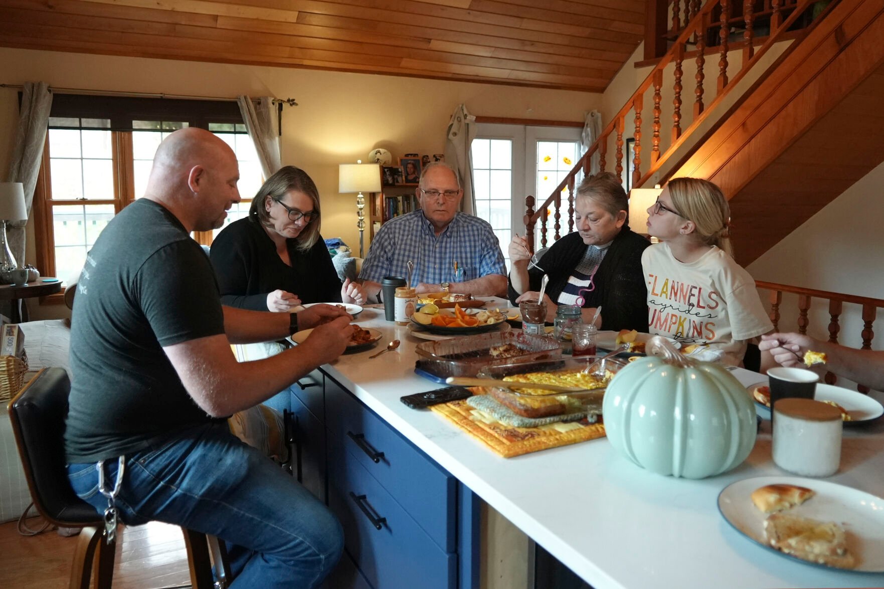 <p>Doug Whitney, center, eats breakfast with his family Nov. 5 in Manson, Wash. Whitney inherited the same gene mutation that gave Alzheimer's disease to his mother, brother and generations of other relatives by the unusually young age of 50. Doug is a healthy 73, his mind still sharp. Somehow, he escaped his genetic fate.</p>