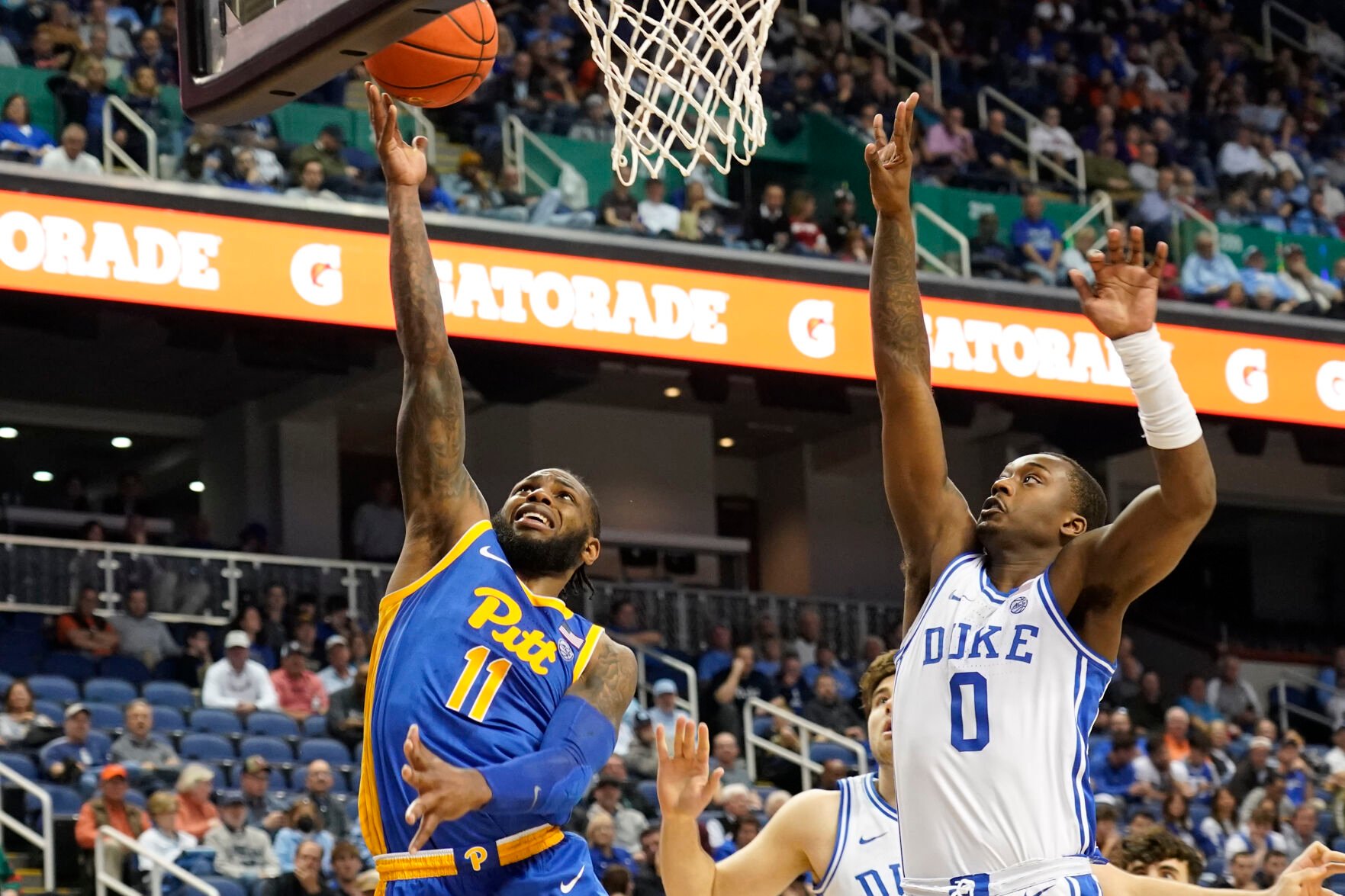 <p>Pittsburgh guard Jamarius Burton drives past Duke forward Dariq Whitehead during the second half of Thursday's quarterfinal game at the Atlantic Coast Conference Tournament in Greensboro, N.C.</p>