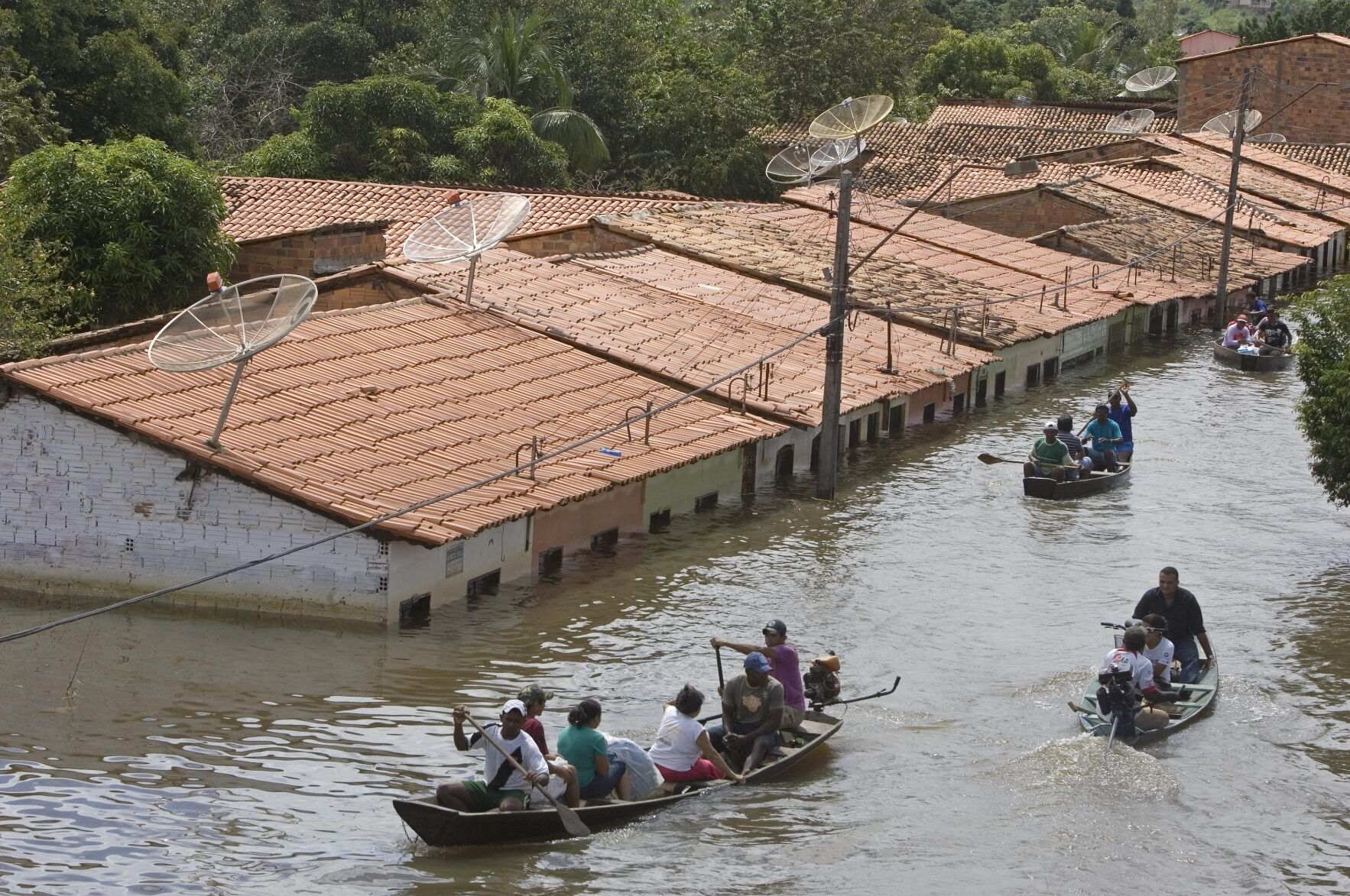 <p>People travel by boat in a flooded street in Trizidela do Vale, state of Maranhao, Brazil, May 9, 2009.</p>