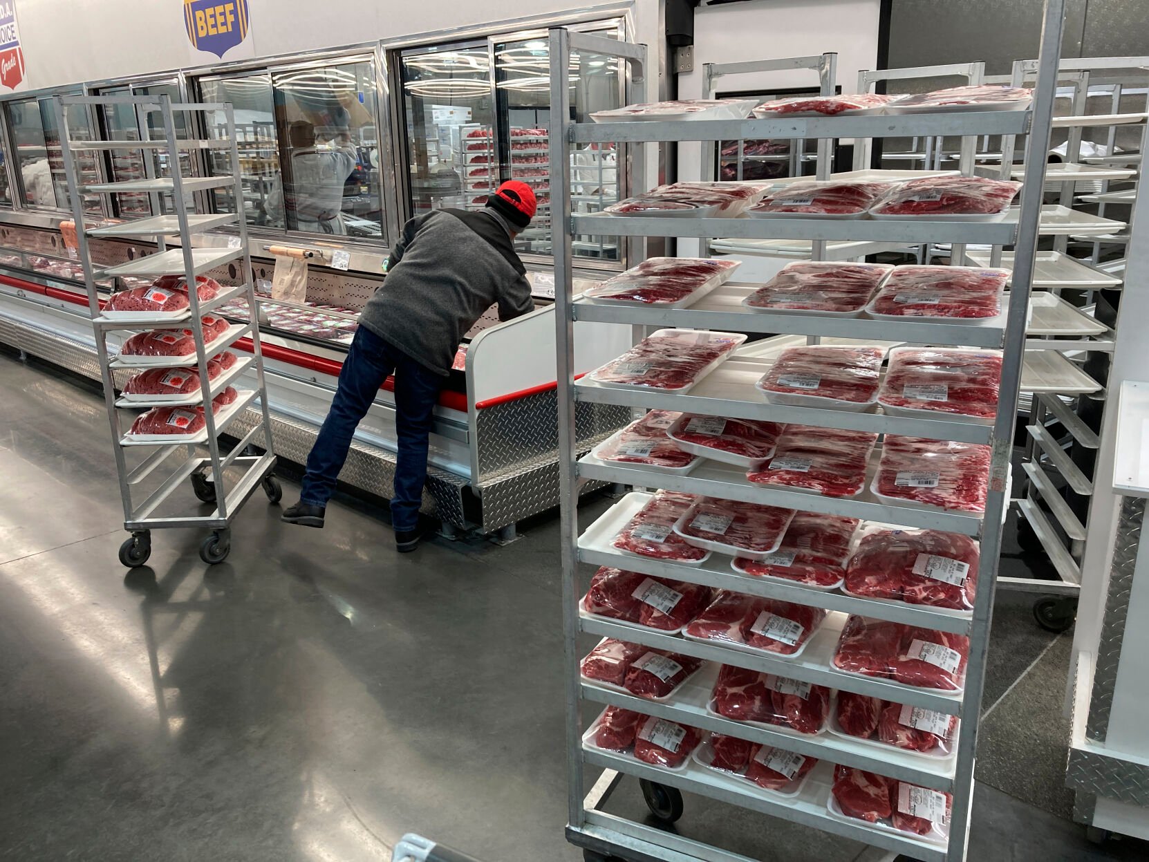 <p>FILE - An employee restocks meats on Jan. 17, 2023, in North Miami, Fla. Greenhouse gas emissions from the way humans consume food could add nearly one degree of warming to the Earth’s climate by 2100, according to a new study Monday, March 6, 2023. Researchers found that the majority of greenhouse gas emissions come from three major food groups — meat from animals like cows, sheep and goats, dairy and rice. (AP Photo/Wilfredo Lee, File)</p>