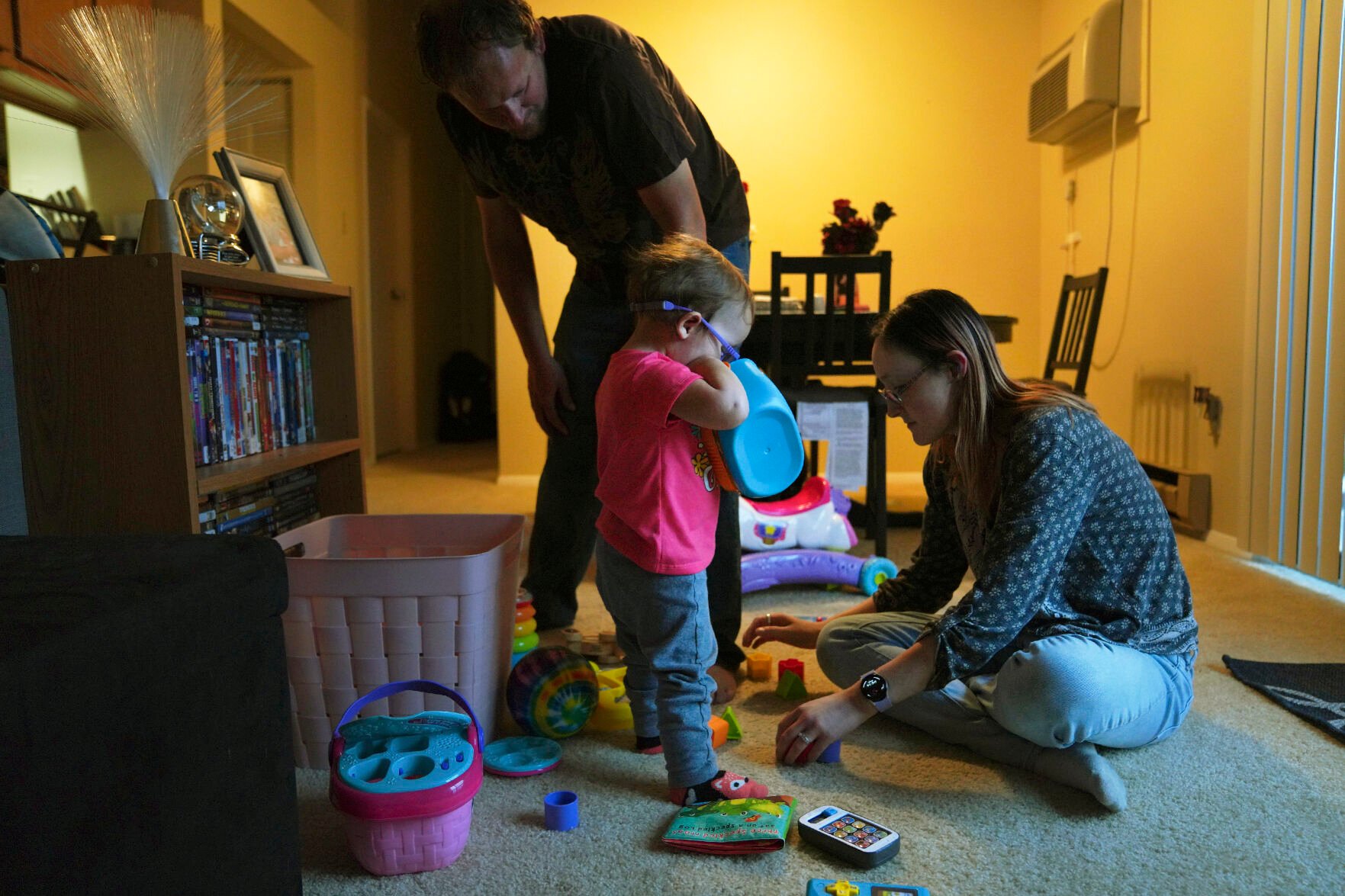 <p>Andrew and Lauren Hackney play with their 1-year-old daughter during a supervised visit at their apartment Nov. 17 in Oakdale, Pa. The Hackneys’ daughter was taken from their custody at 8 months old when the couple brought her to the children's hospital in Pittsburgh after having difficulty feeding her. They believe hospital staff alerted the Allegheny County Department of Human Services.</p>